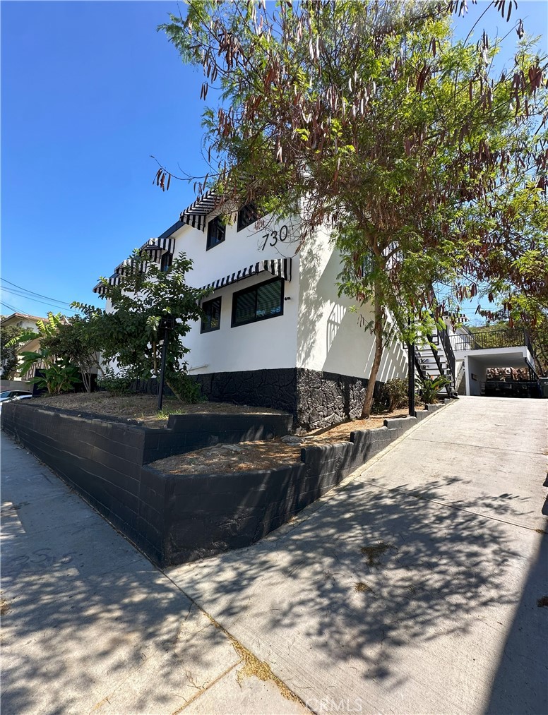 a view of a house with snow on the road