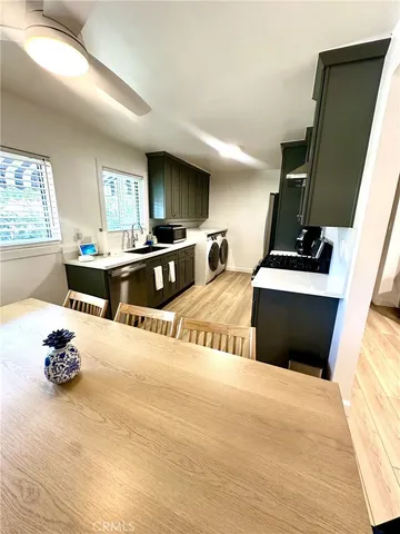 a kitchen with stainless steel appliances a stove a sink and a refrigerator