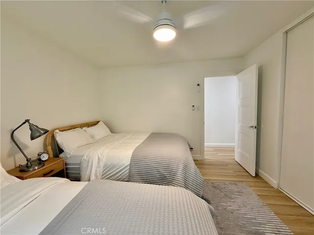 a bedroom with two beds and a chair