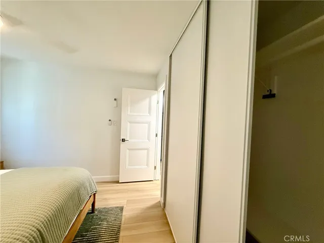 a view of closet with wooden floor