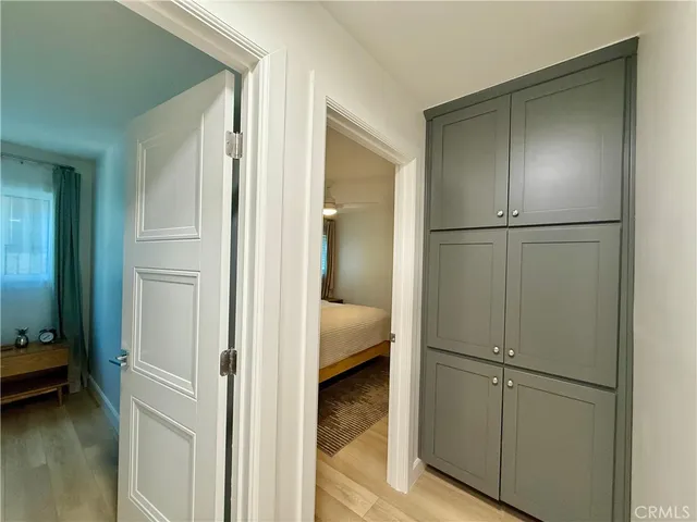 a bedroom with a bed a window with wooden floor