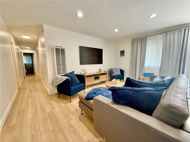 a view of a dining room with furniture and a chandelier