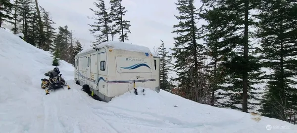 a white house covered with snow in the background