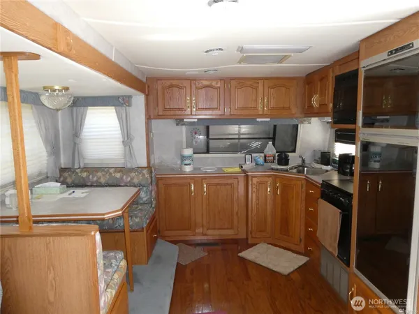 a kitchen with a sink appliances and cabinets