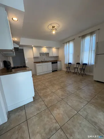 a kitchen with lots of counter top space and furniture