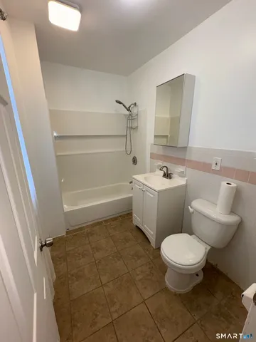 a bathroom with a toilet a sink and a shower