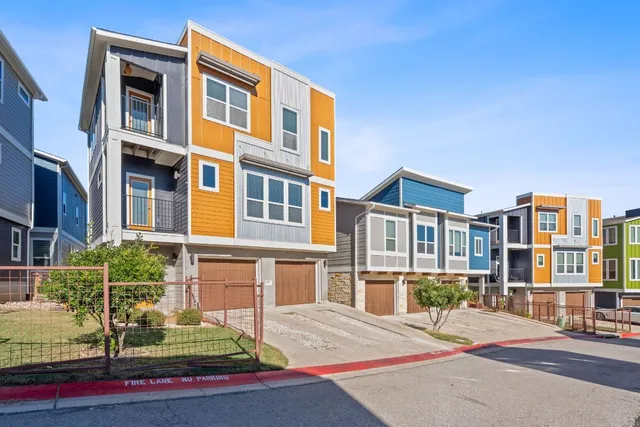 a view of a big house with a big yard and potted plants