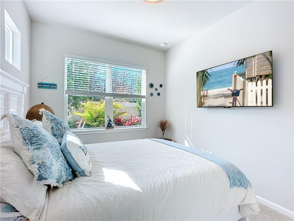 4664 Arboretum Circle, Unit 101 Naples, FL 34112 - Photo 20 of 48 a bedroom with a bed and window