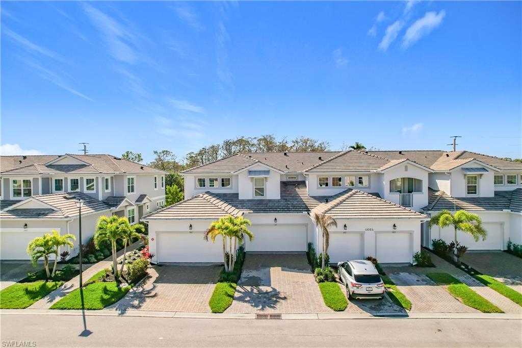 4664 Arboretum Circle, Unit 101 Naples, FL 34112 - Photo 2 of 48 an aerial view of a house with a swimming pool