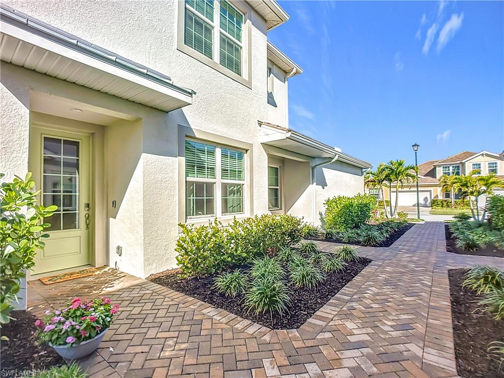 4664 Arboretum Circle, Unit 101 Naples, FL 34112 - Photo 3 of 48 a view of a backyard with potted plants