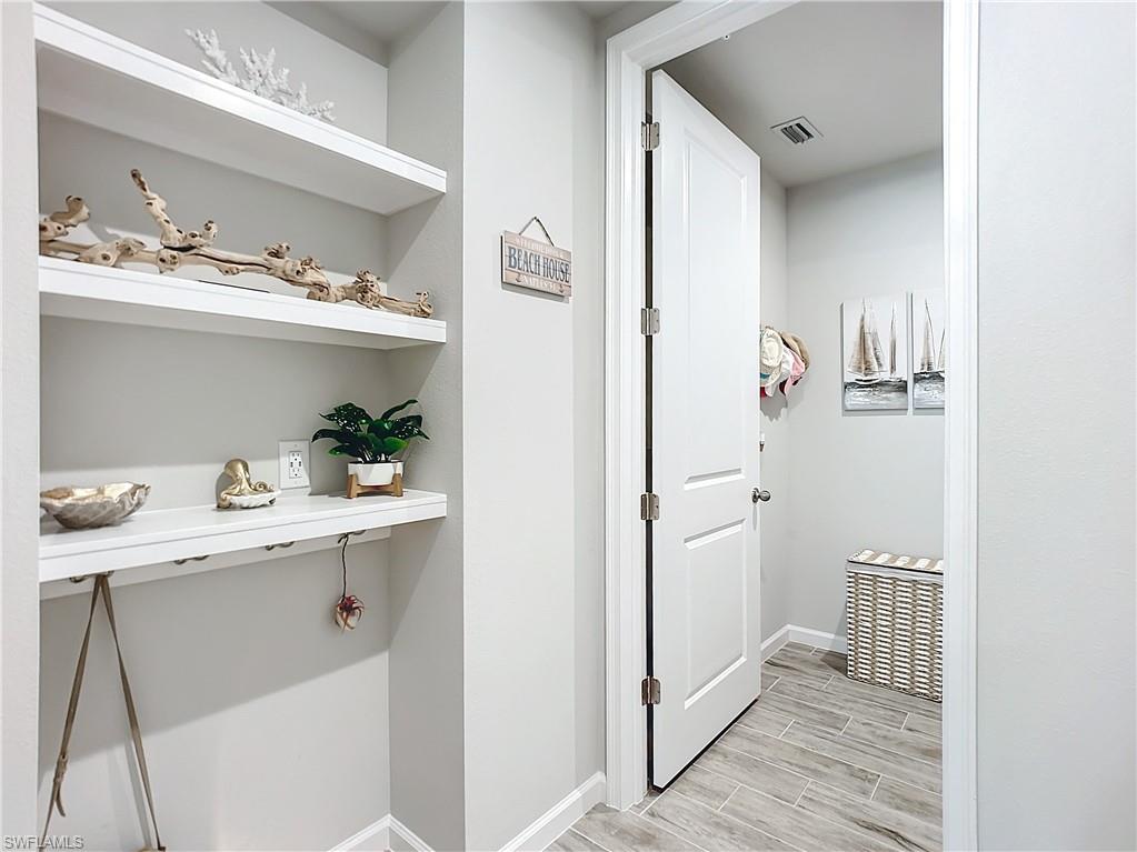 4664 Arboretum Circle, Unit 101 Naples, FL 34112 - Photo 35 of 48 a view of cabinets a sink and dishwasher in a kitchen