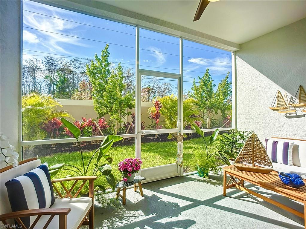 4664 Arboretum Circle, Unit 101 Naples, FL 34112 - Photo 38 of 48 a view of a chairs and table in a patio