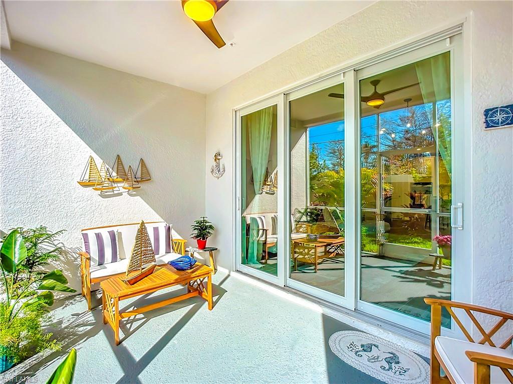 4664 Arboretum Circle, Unit 101 Naples, FL 34112 - Photo 40 of 48 a bench is sitting in front of a building