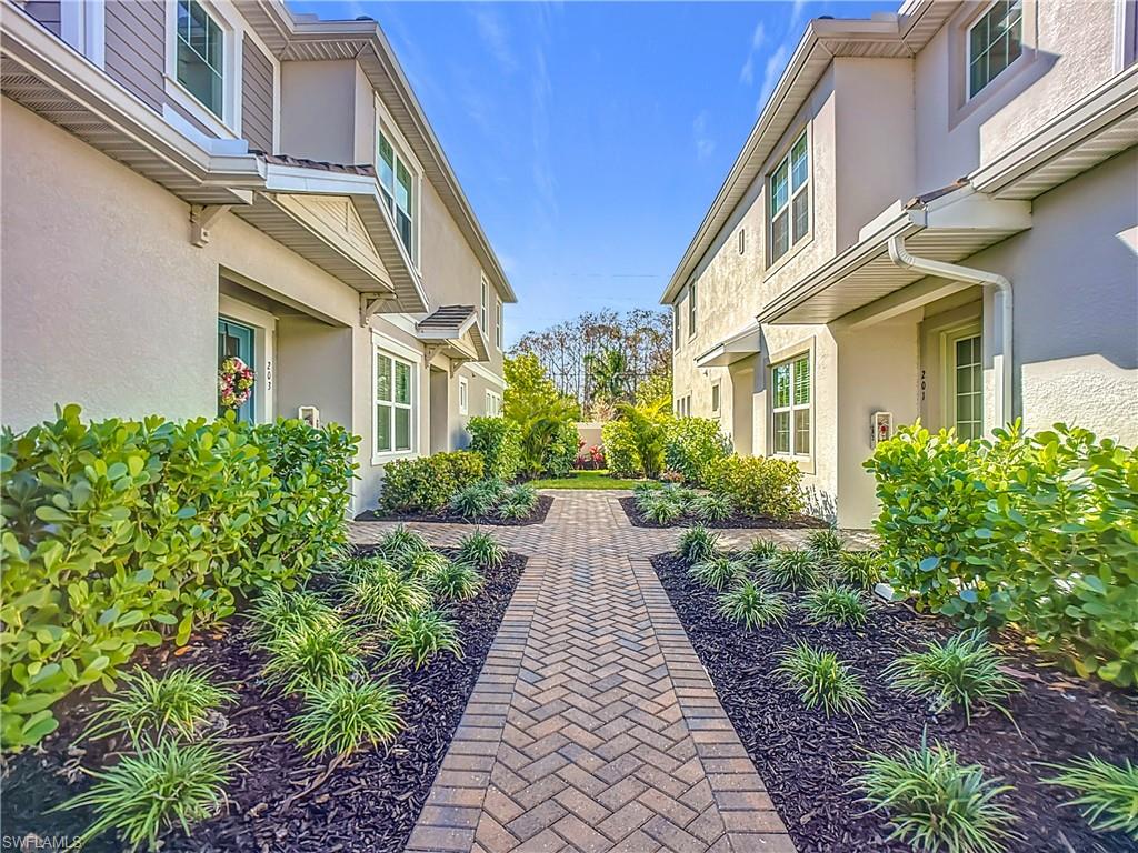 4664 Arboretum Circle, Unit 101 Naples, FL 34112 - Photo 5 of 48 a view of a pathway both side of the house