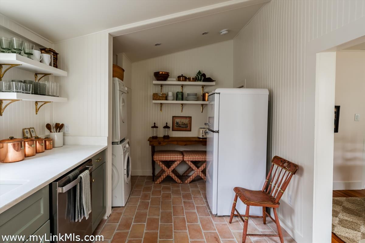 10 Centre Street Nantucket, MA 02554 - Photo 14 of 43 a room with a chair and white cabinets