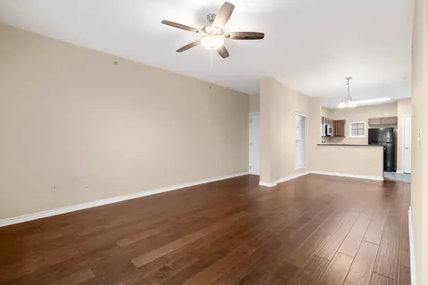a view of a kitchen with wooden floor and a kitchen space