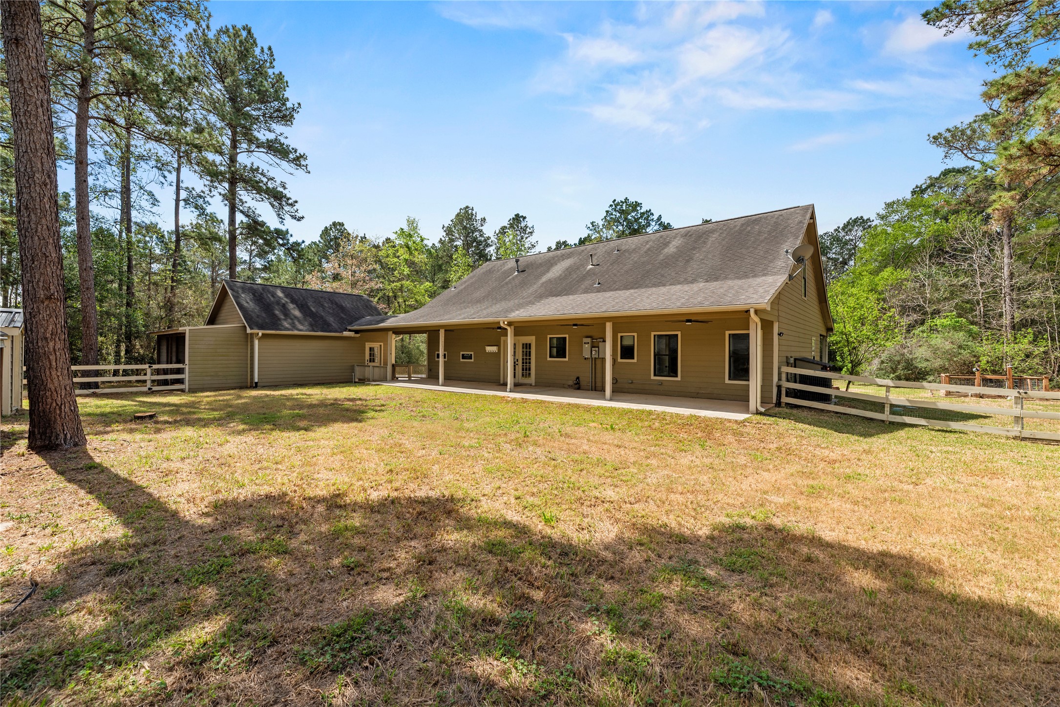 12062 Ike White Road Conroe, TX 77303 - Photo 28 of 37 Backyard with a covered patio.