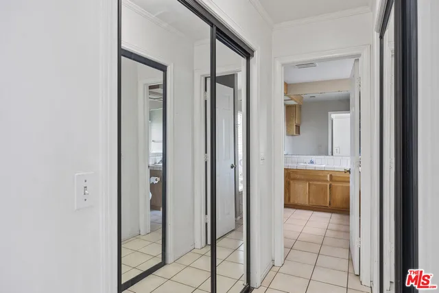 a bathroom with a granite countertop sink a mirror and a bathtub