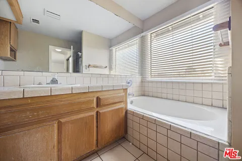 a bathroom with a bathtub and a sink