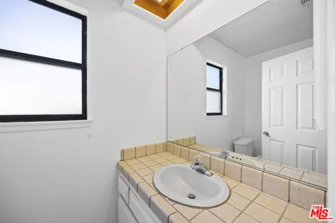 a bathroom with a sink mirror and vanity