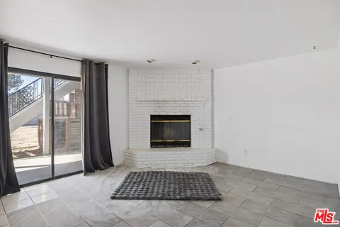 a living room with a fireplace and a rug