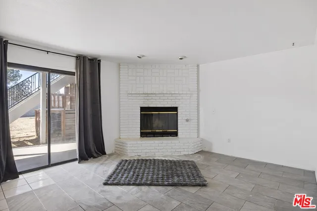 a living room with a fireplace and a rug
