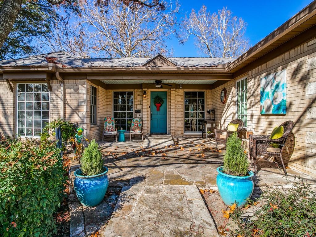 a view of a patio with table and chairs potted plants