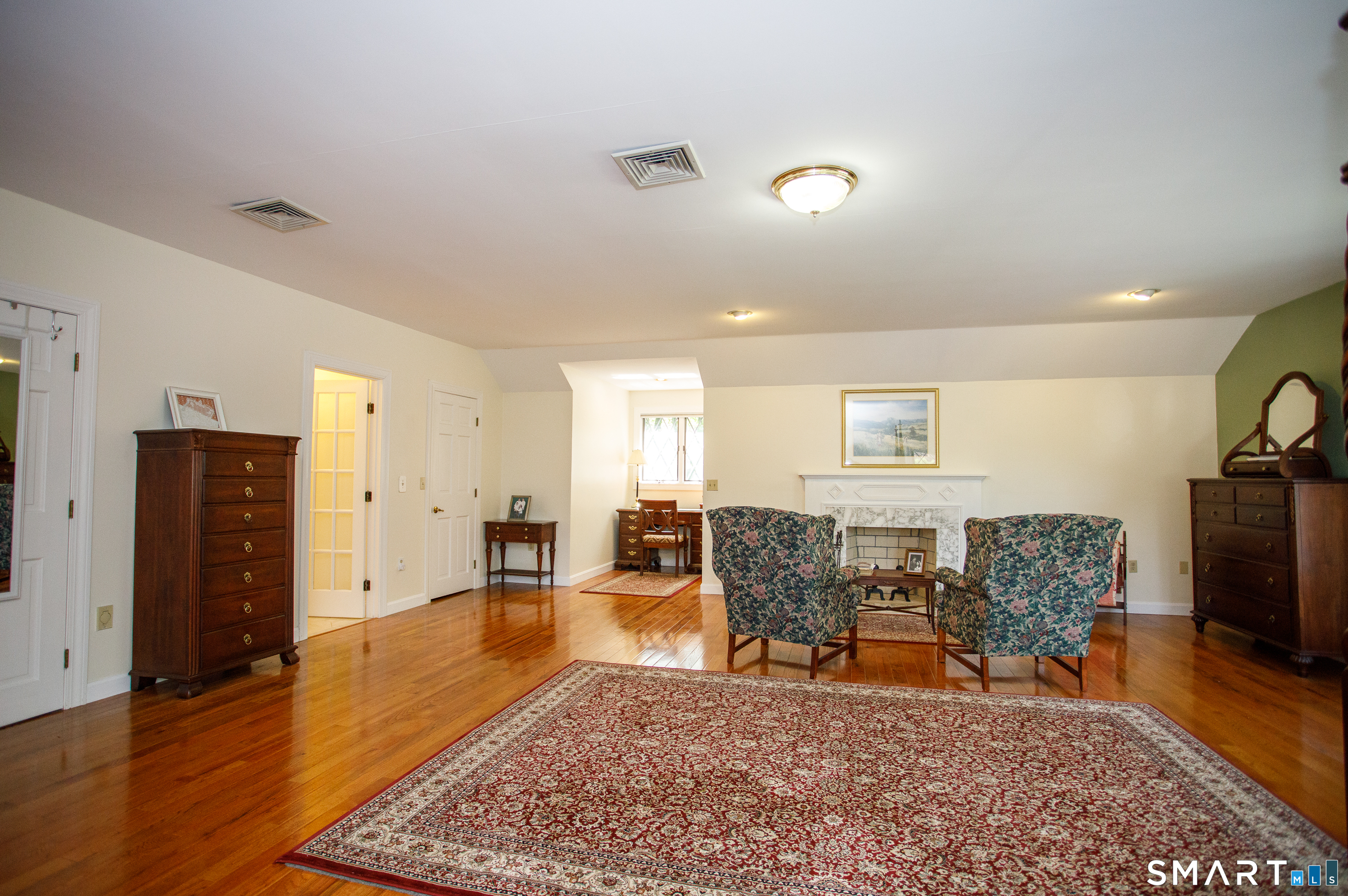 25 Stony Ridge Road Norwich, CT 06360 - Photo 21 of 40 a living room with furniture a wooden floor and a flat screen tv