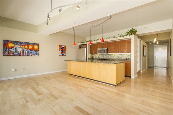 a view of kitchen with stainless steel appliances granite countertop a stove and a sink