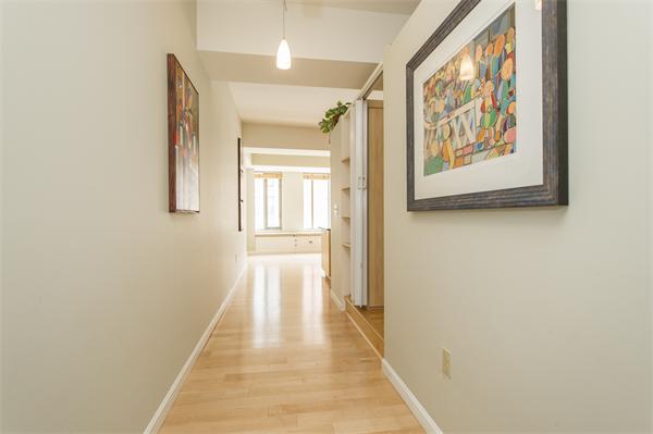 1313 Washington Street, Unit 310 Boston, MA 02118 - Photo 5 of 14 a view of a hallway with wooden floor and a bathroom