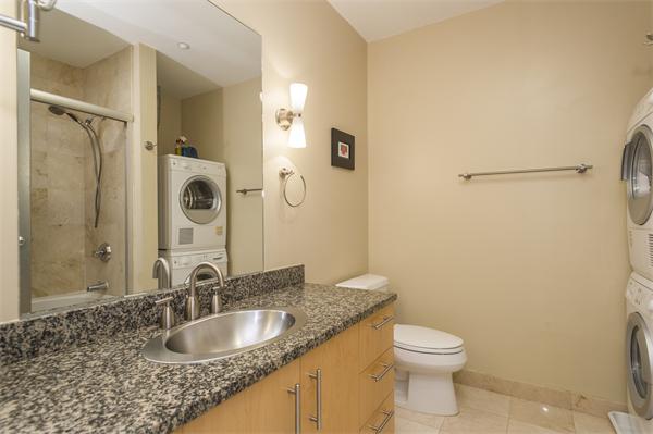 1313 Washington Street, Unit 310 Boston, MA 02118 - Photo 7 of 14 a bathroom with a granite countertop sink toilet and shower