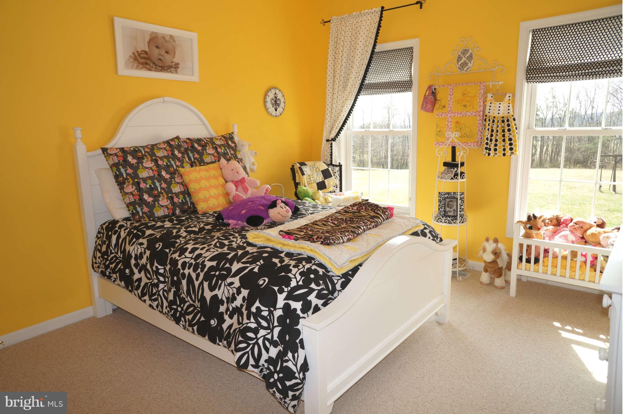 251 Ridgeview Road Gore, VA 22637 - Photo 14 of 21 a bed sitting in a bedroom next to a window