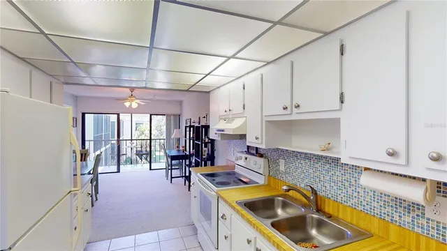 a kitchen with stainless steel appliances granite countertop a sink a stove and cabinets