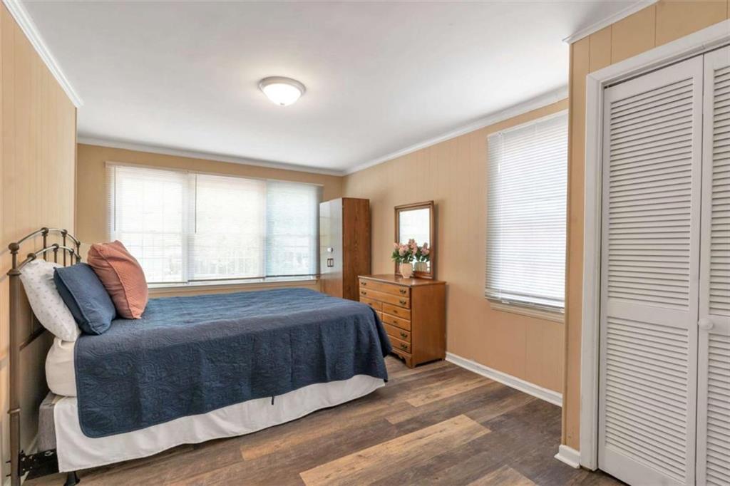 1766 Brewer Boulevard Southwest Atlanta, GA 30310 - Photo 11 of 30 a bedroom with a bed and wooden floor