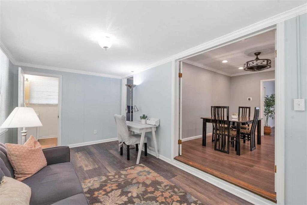 1766 Brewer Boulevard Southwest Atlanta, GA 30310 - Photo 12 of 30 a living room with furniture and a dining table with rug