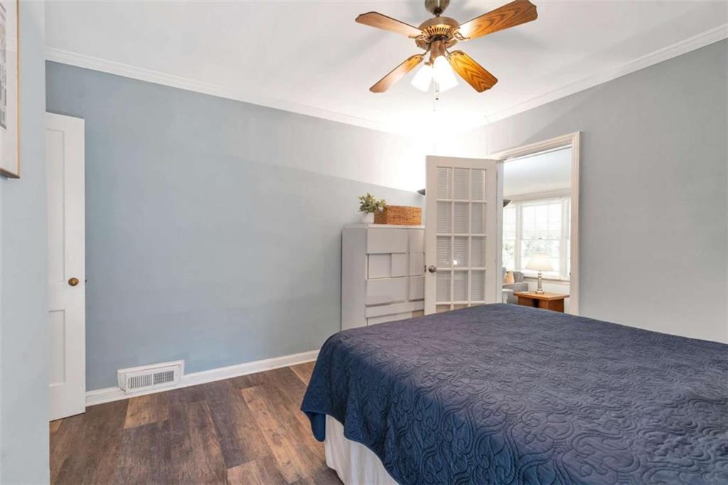 1766 Brewer Boulevard Southwest Atlanta, GA 30310 - Photo 14 of 30 a bedroom with a bed and a chandelier