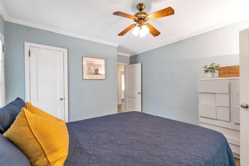 1766 Brewer Boulevard Southwest Atlanta, GA 30310 - Photo 15 of 30 a bedroom with a bed and a painting on the wall