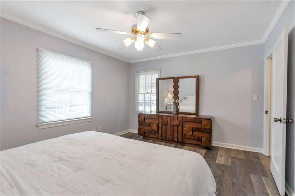 1766 Brewer Boulevard Southwest Atlanta, GA 30310 - Photo 16 of 30 a bedroom with a bed and a chandelier