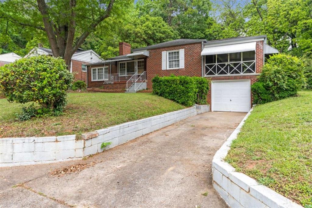 1766 Brewer Boulevard Southwest Atlanta, GA 30310 - Photo 2 of 30 front view of house with a yard and potted plants