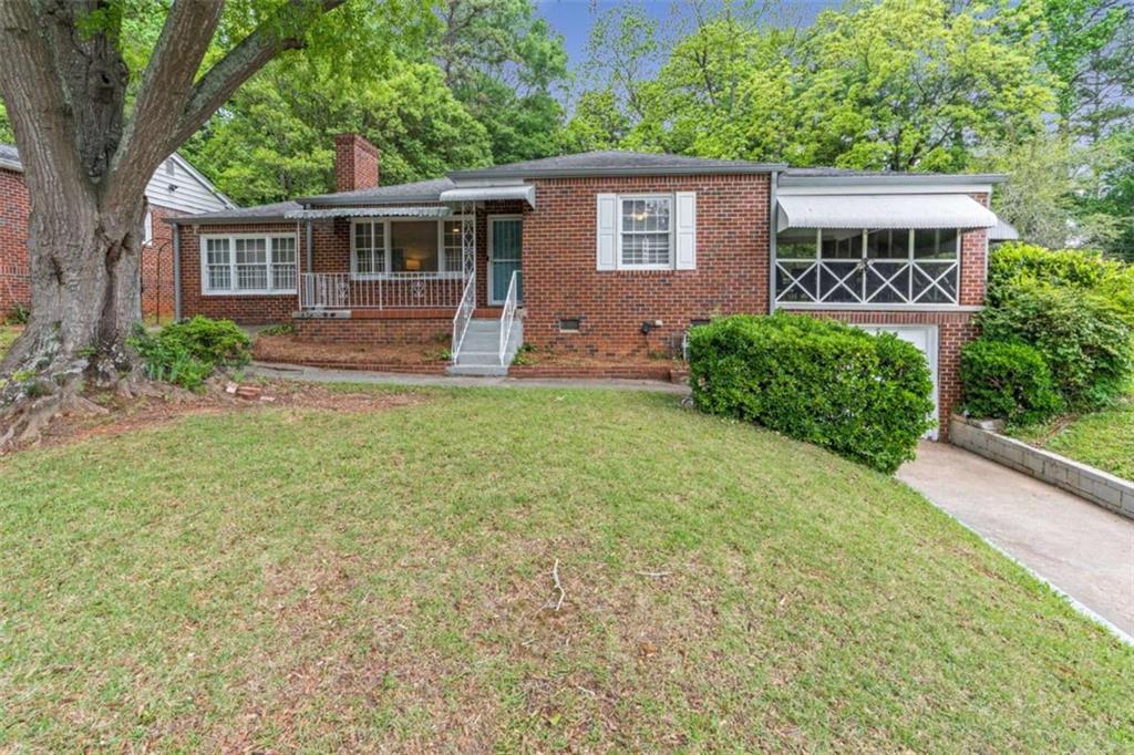 1766 Brewer Boulevard Southwest Atlanta, GA 30310 - Photo 26 of 30 front view of a house with a yard