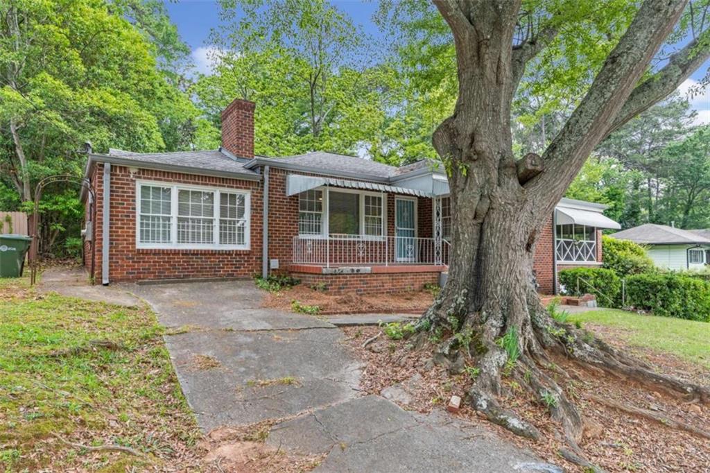 1766 Brewer Boulevard Southwest Atlanta, GA 30310 - Photo 27 of 30 front view of a house with a tree in front