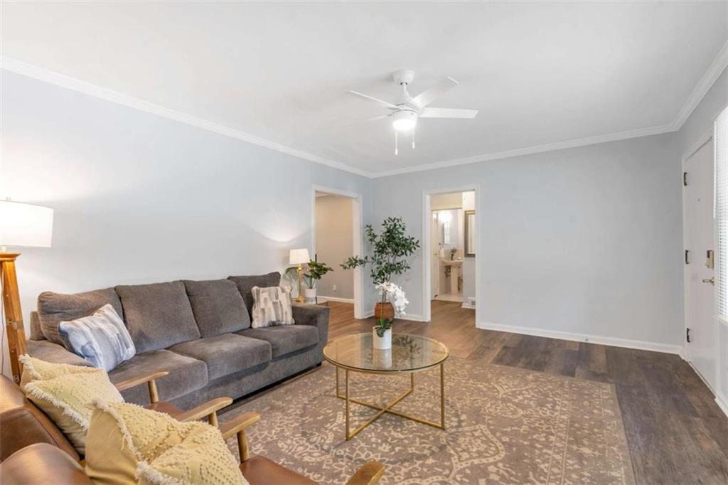 1766 Brewer Boulevard Southwest Atlanta, GA 30310 - Photo 4 of 30 a living room with furniture and a chandelier