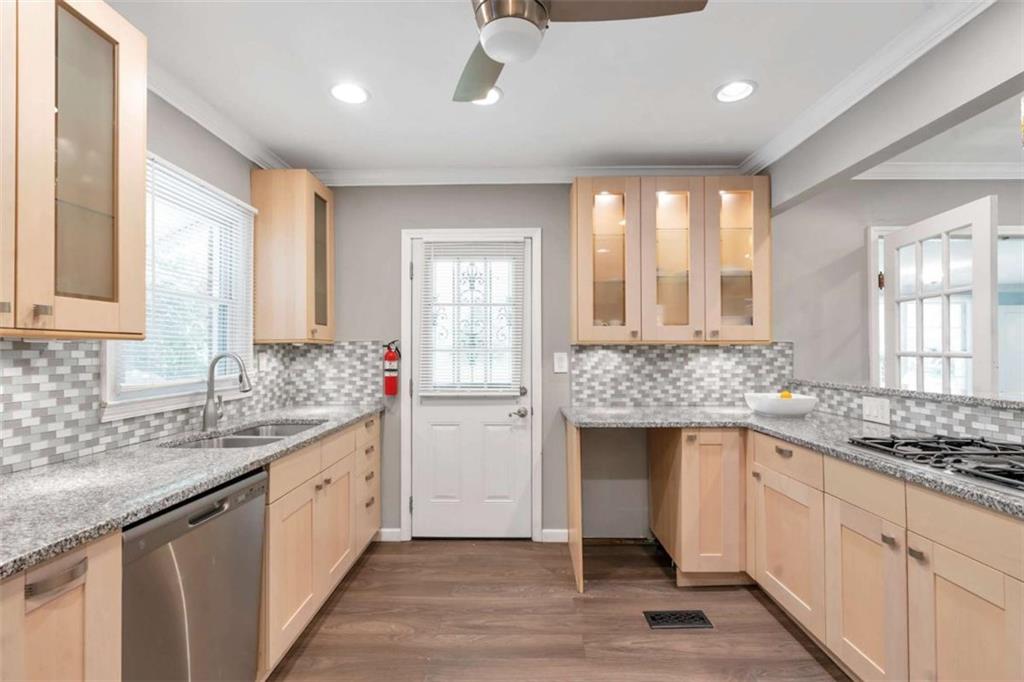1766 Brewer Boulevard Southwest Atlanta, GA 30310 - Photo 6 of 30 a kitchen with granite countertop a sink and a window