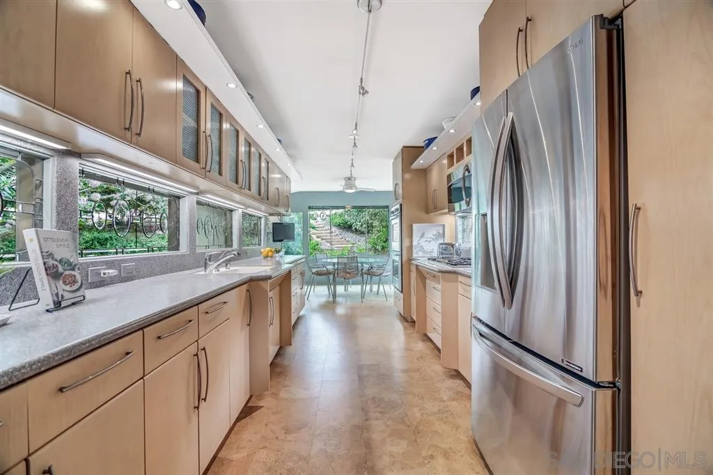 1615 Lugano Lane Del Mar, CA 92014 - Photo 4 of 25 a kitchen with stainless steel appliances a refrigerator and a sink