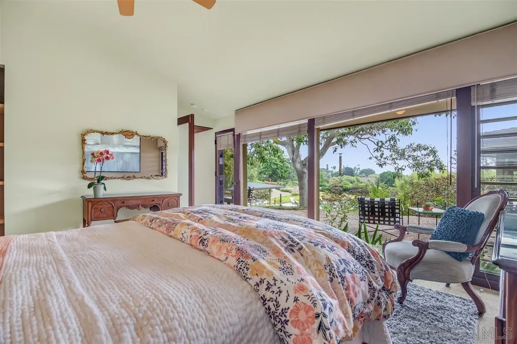 1615 Lugano Lane Del Mar, CA 92014 - Photo 7 of 25 a bedroom with a bed a couch and large window