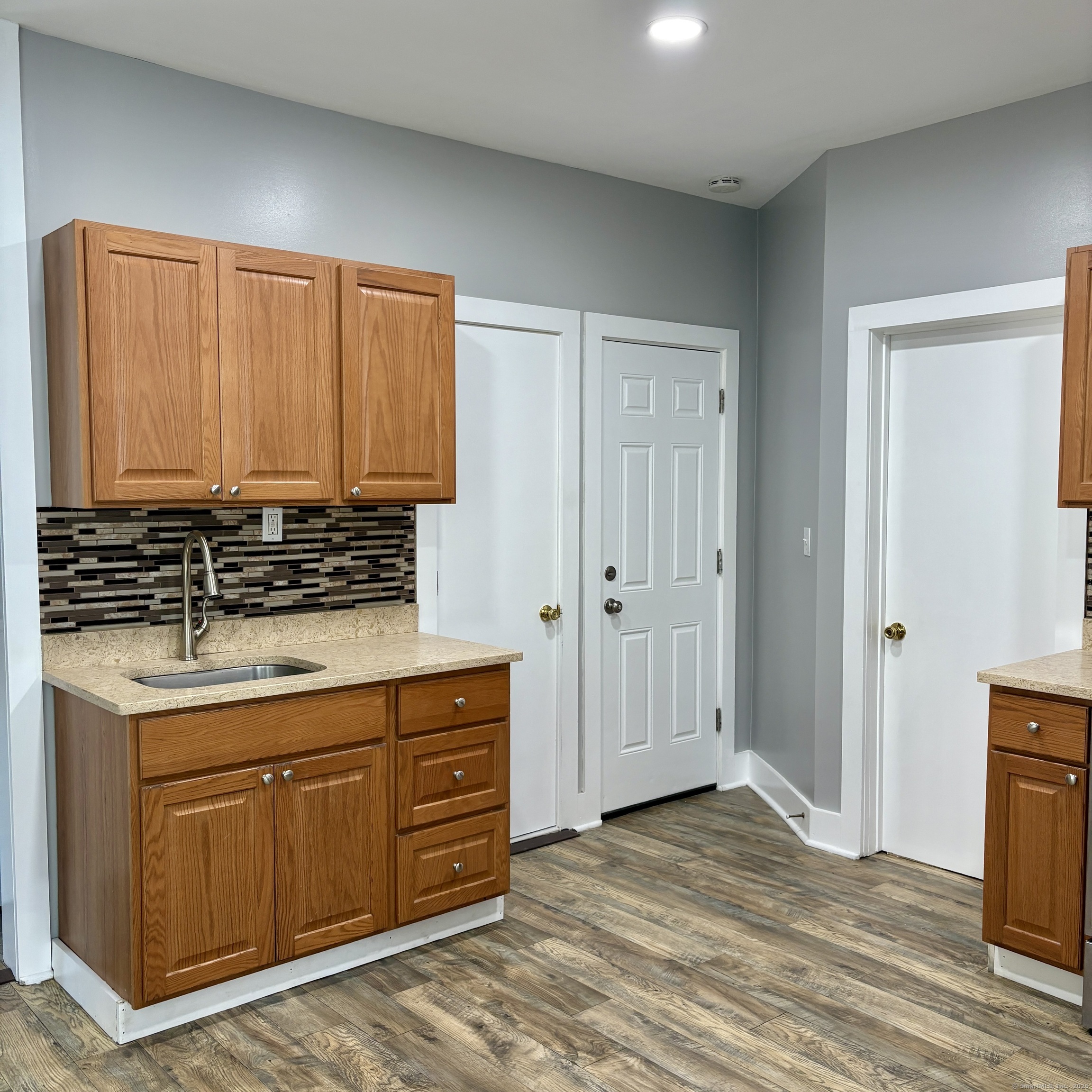 76 Commercial Street, Unit 1 Bridgeport, CT 06604 - Photo 4 of 9 a kitchen with stainless steel appliances granite countertop a stove and a refrigerator
