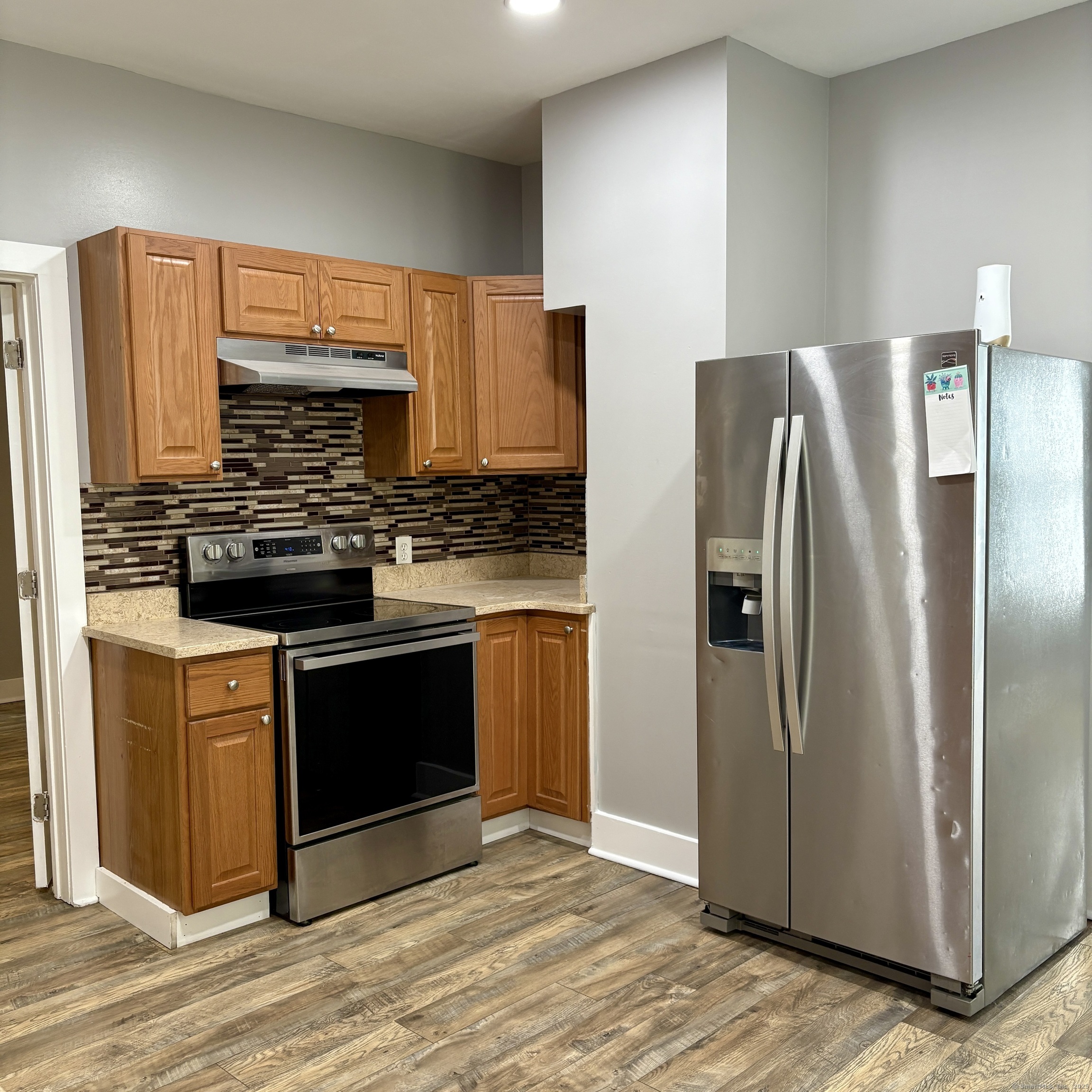 76 Commercial Street, Unit 1 Bridgeport, CT 06604 - Photo 5 of 9 a kitchen with stainless steel appliances granite countertop a refrigerator and a stove