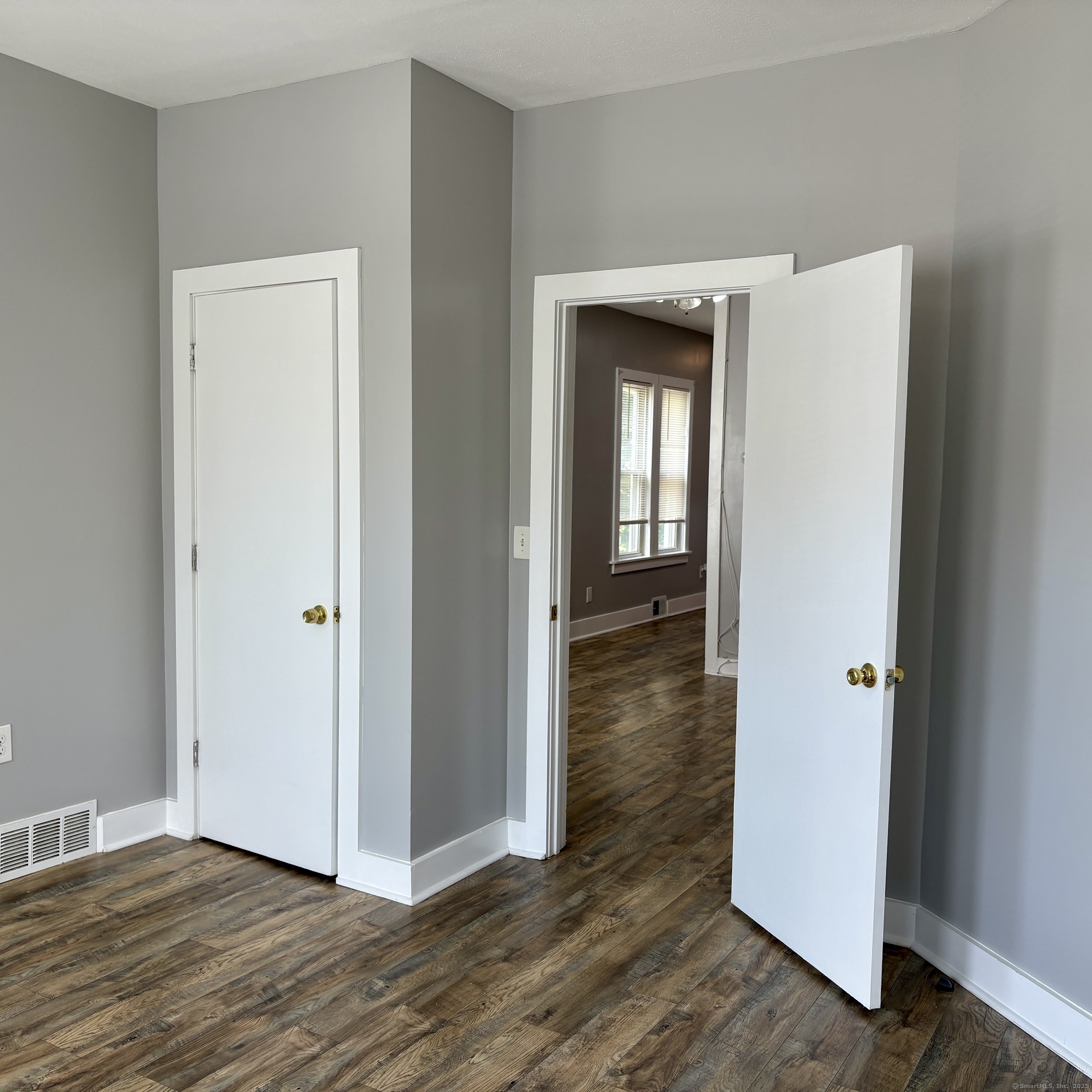 76 Commercial Street, Unit 1 Bridgeport, CT 06604 - Photo 8 of 9 a view of a hallway with wooden floor
