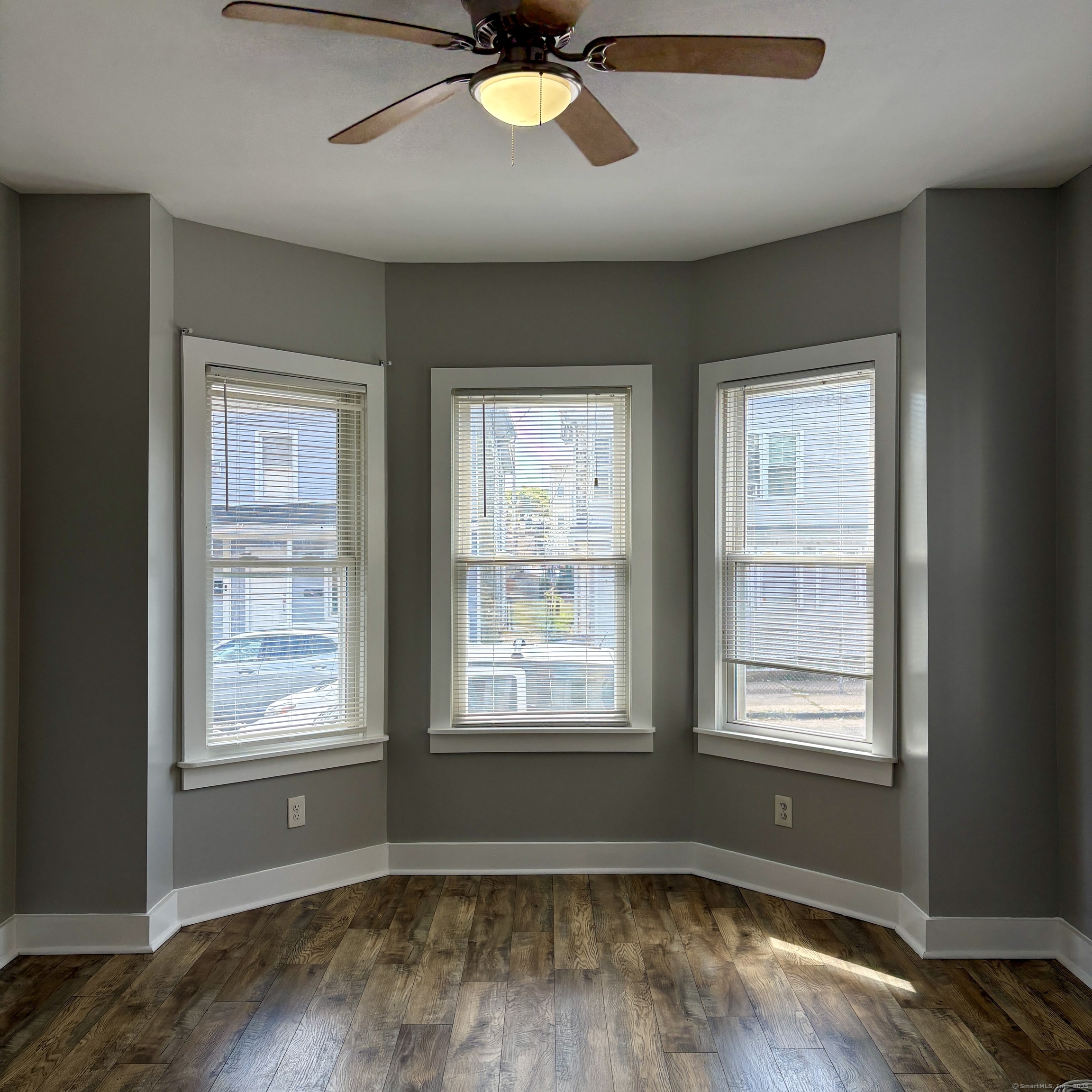 76 Commercial Street, Unit 1 Bridgeport, CT 06604 - Photo 9 of 9 a view of an empty room with wooden floor and a window
