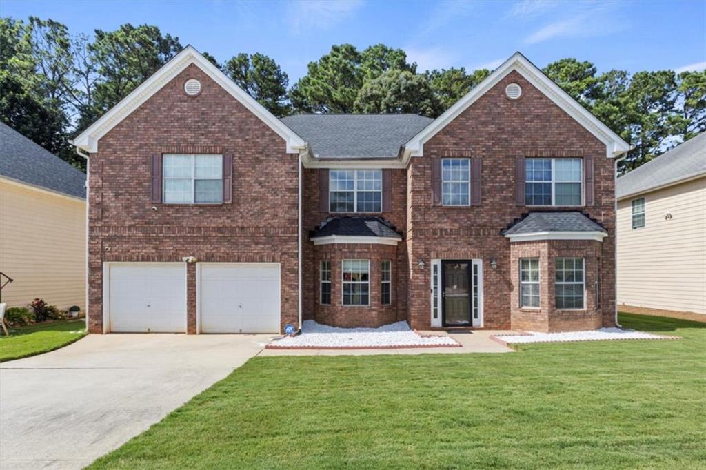 802 Cormac Drive Riverdale, GA 30296 - Photo 1 of 1 a front view of a house with a yard